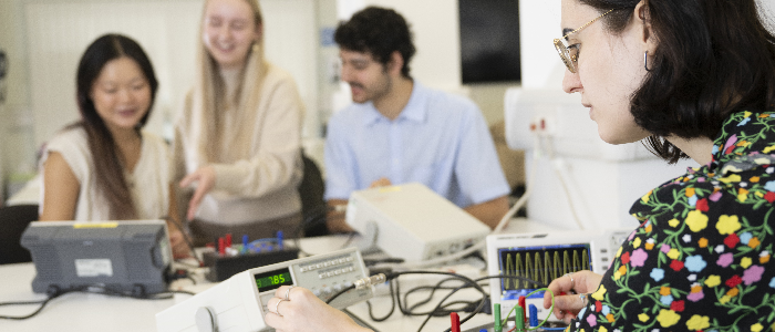 Four students working together on physics research