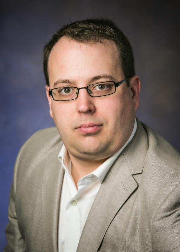 Portrait of Dr. Mark D. Butala, a Senior Lecturer at Glasgow College, Hainan	