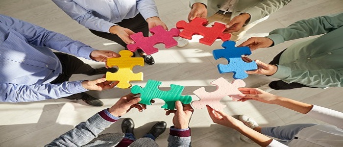 People holding jigsaw pieces