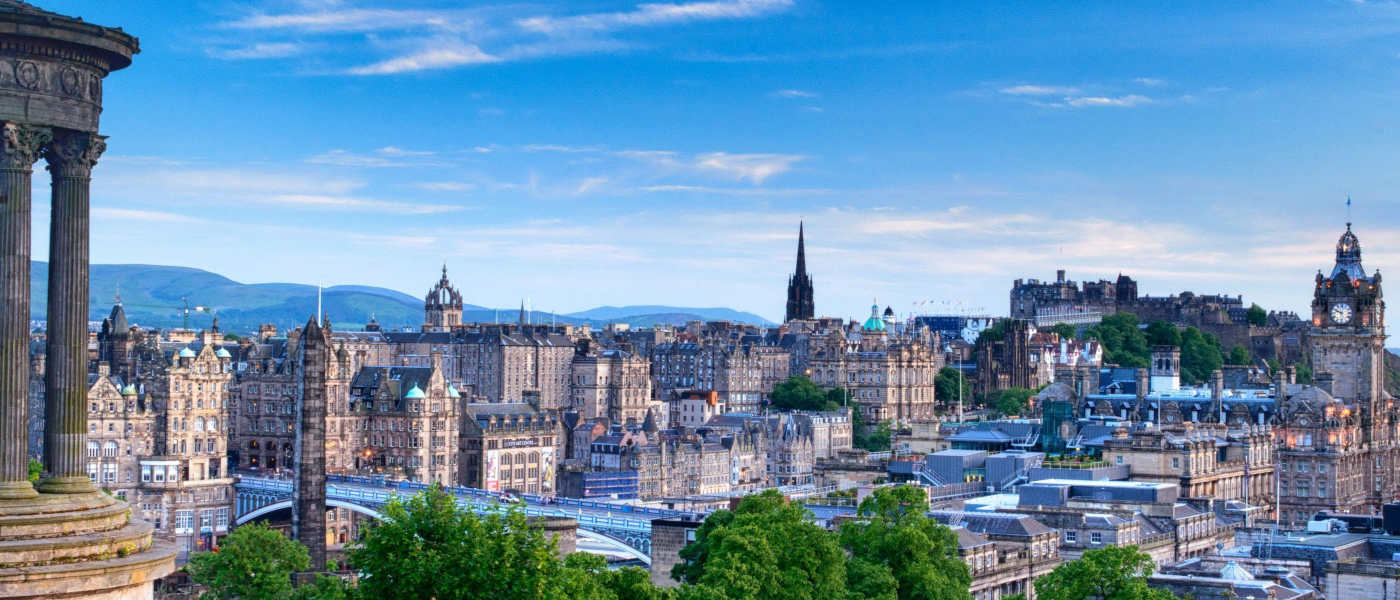 Edinburgh city skyline during the day, with a beautiful blue sky