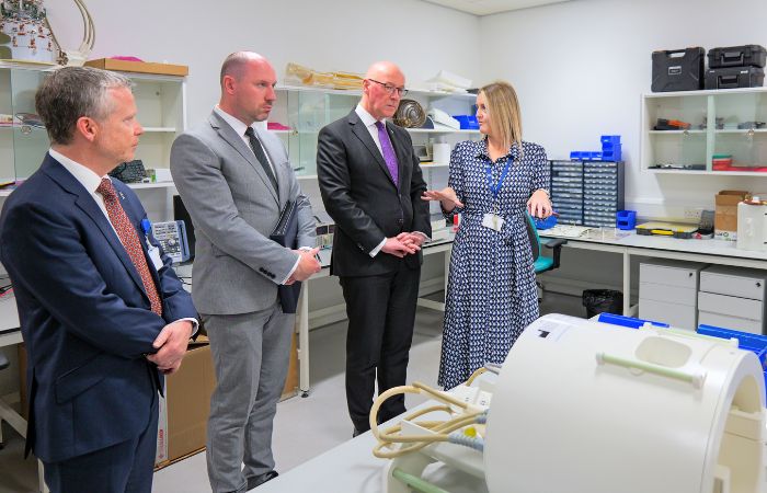 First Minister John Swinney Looking at MRI Head Coil