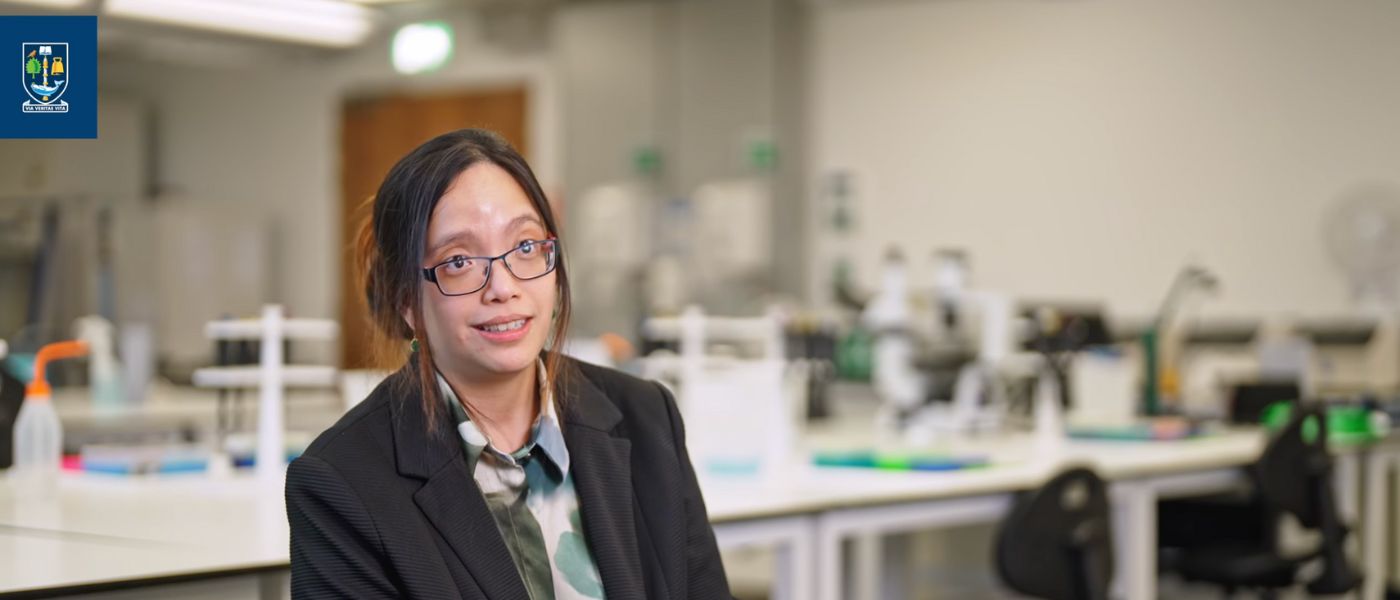 A woman speaking to camera in a laboratory setting