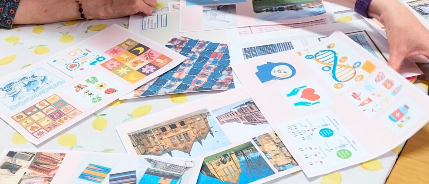 Printed examples of woven tapestries lying on a table