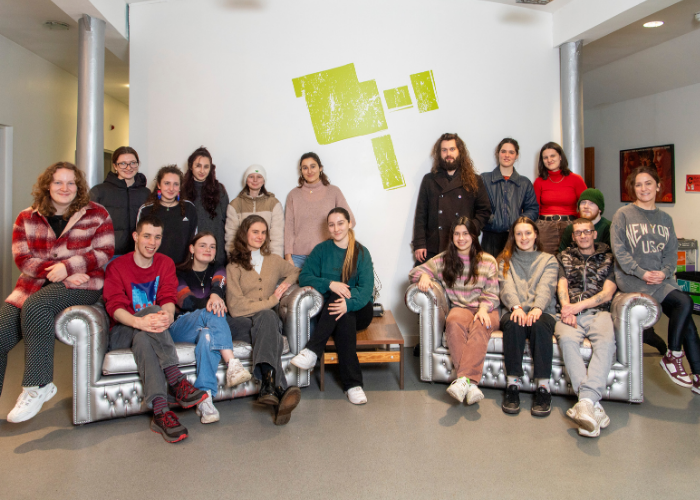 students from the applied dissertation sitting in front of the GMAC logo