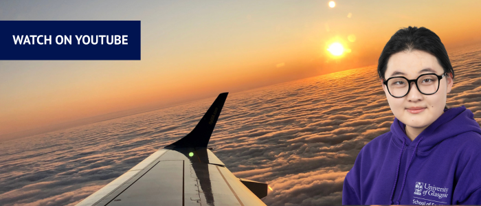 View from a plane window over the clouds with headshot of smiling woman