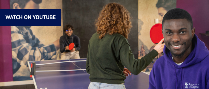 Two people playing table tennis with headshot of smiling man