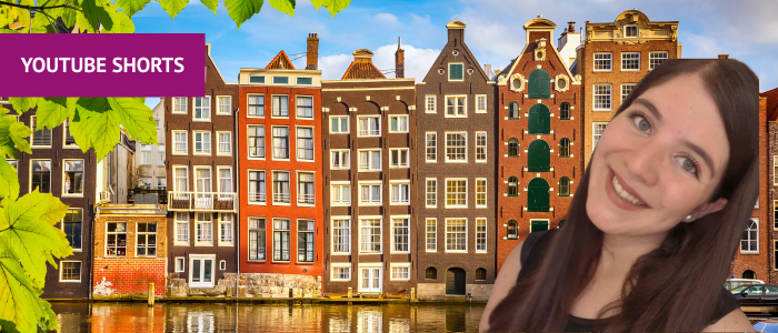 Canal houses next to a canal in Amsterdam with headshot of smiling woman