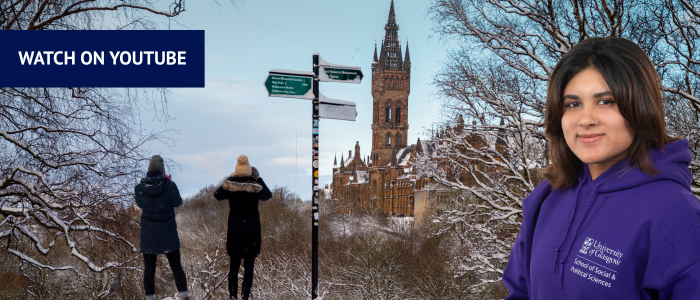 View of the Gilbert Scott tower in the snow with two people looking at it next to a signpost with headshot of smiling woman