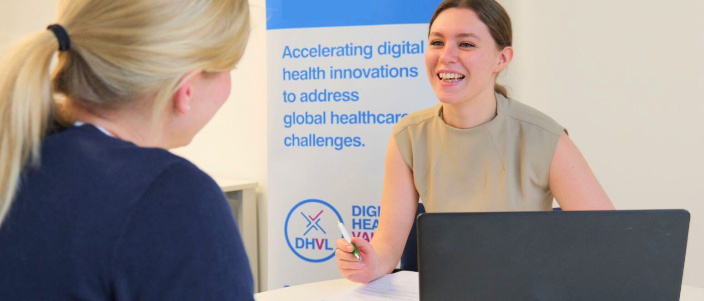 Two people sitting at a table in a consultancy-style setting