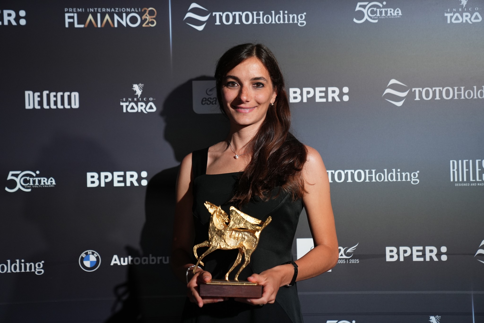 Claudia Dellacasa holding an award