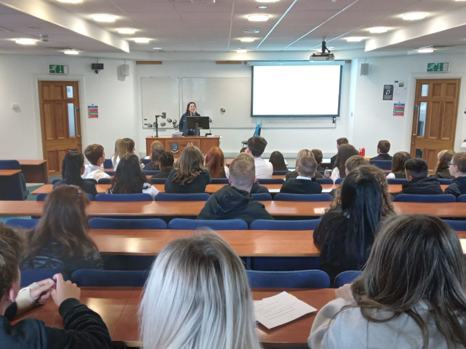 Monica Legazpi Iglesias stand before a classroom of high school students as a part of the SMLC taster sessions