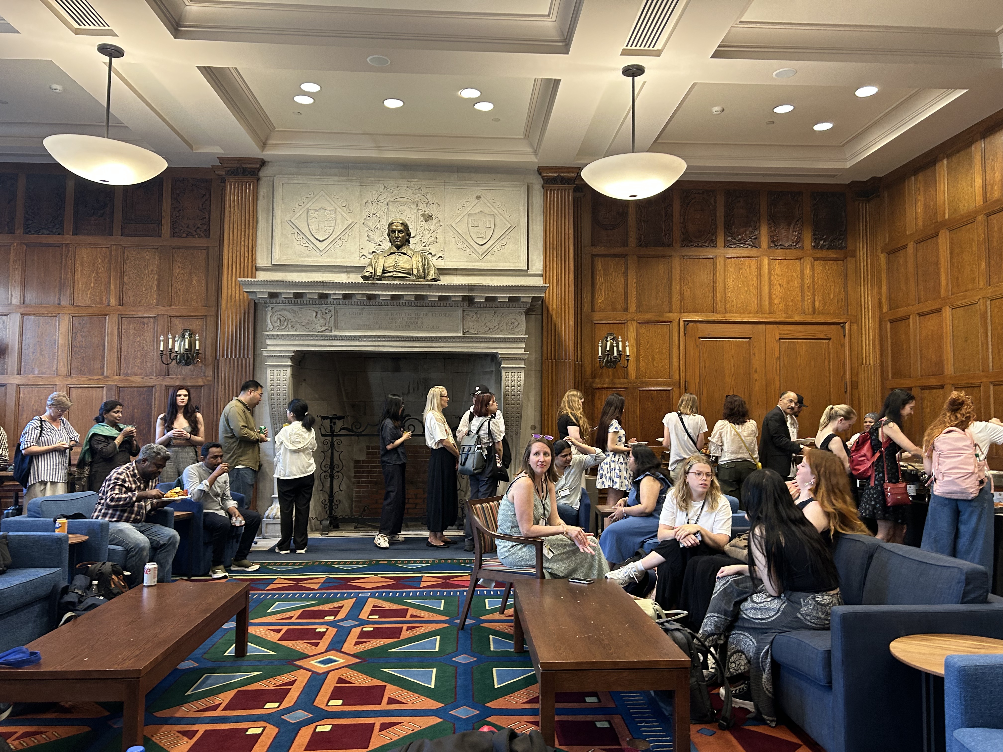 A crowd of students and researchers congregating in a room at Harvard University