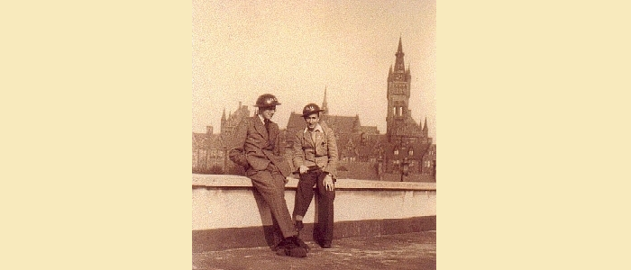 Two men in helmets pose on the Chemistry Building roof while firewatching in the early 1940s