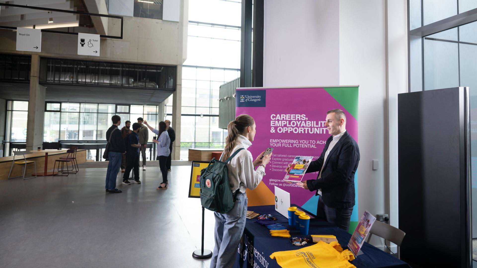 Employer speaking to student in The Plaza space in the James McCune Smith Learning Hub