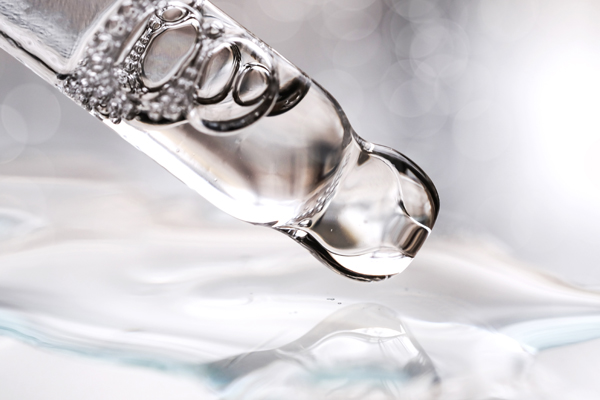 Close-up of a pipette, containing clear fluid