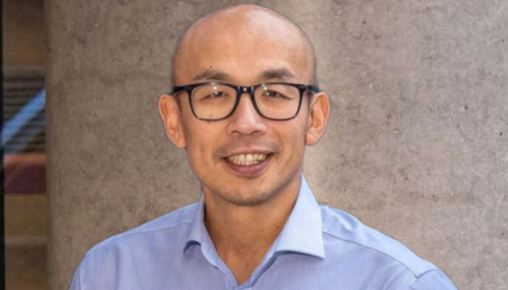 A head and shoulders portrait shot of professor gwo-tzer ho outdoors