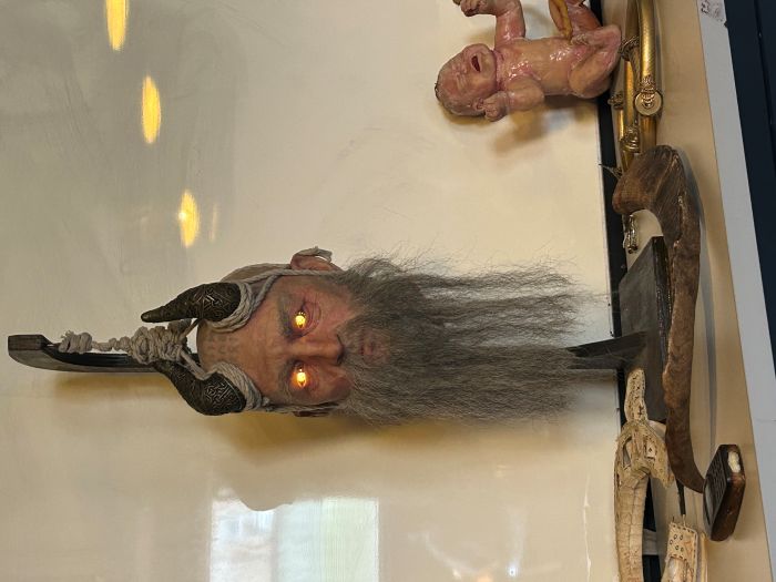 A prop of a persons head and a baby