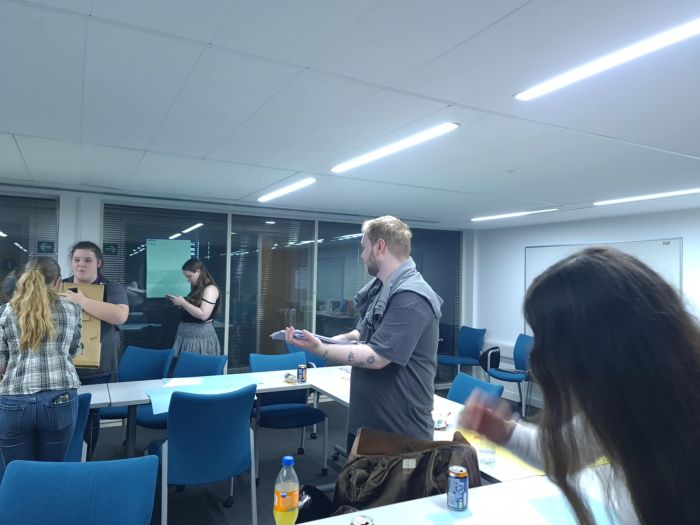 People standing in Gilmorehill Halls meeting room