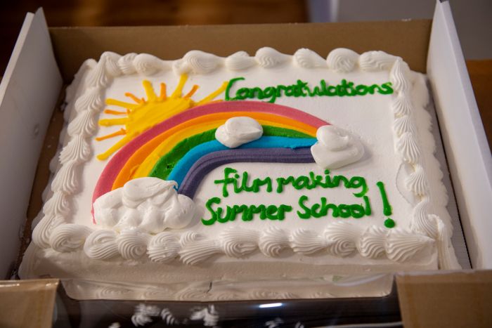 a cake that says 'Congratulations, film making summer school!' with a rainbow and sun