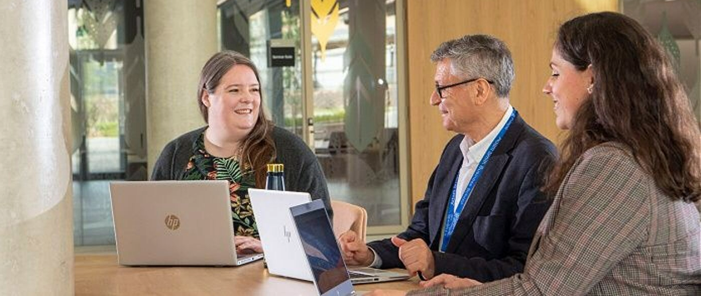 A group of business people gathered around a table having a meeting