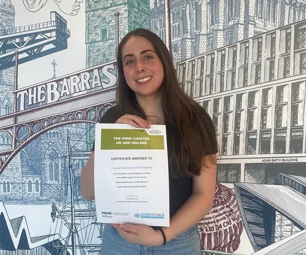 Photo of Anael, RSM SDG Competition Winner holding her certificate