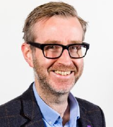 A head and shoulders portrait shot of Professor Robert Gray set against a white background