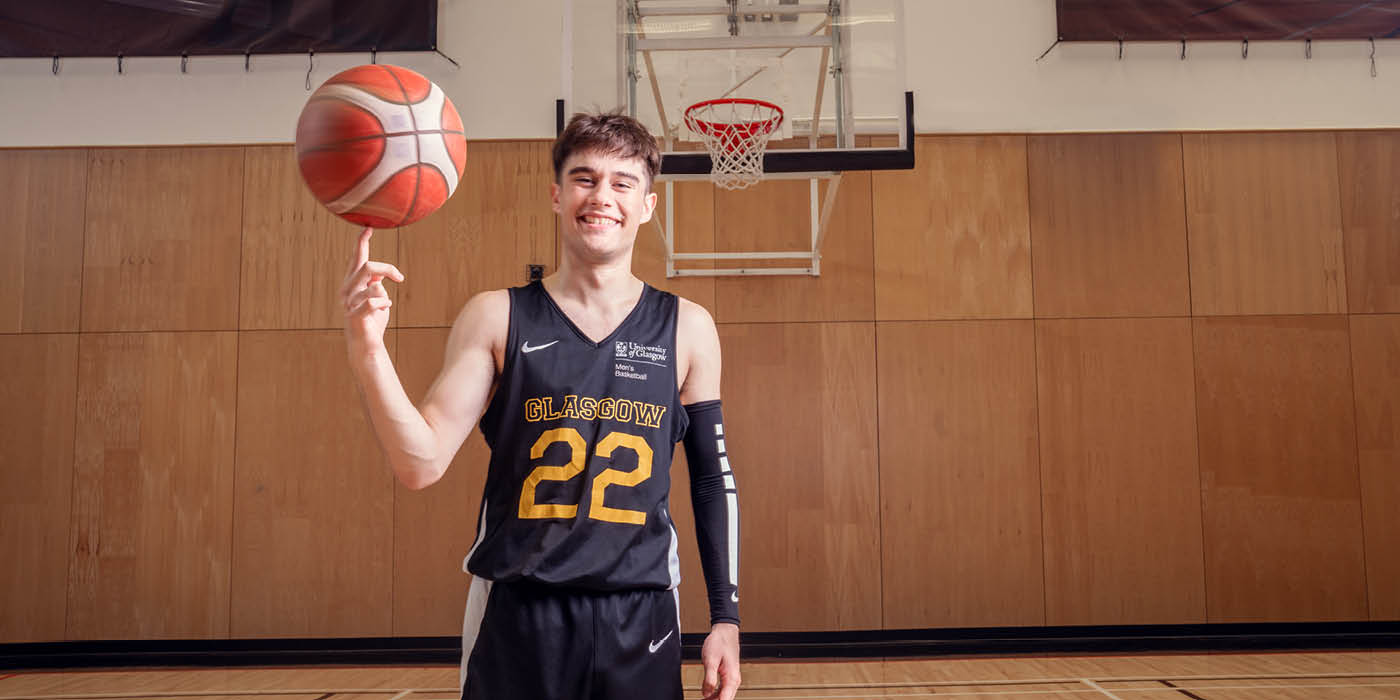 Male student spinning a basketball on his finger