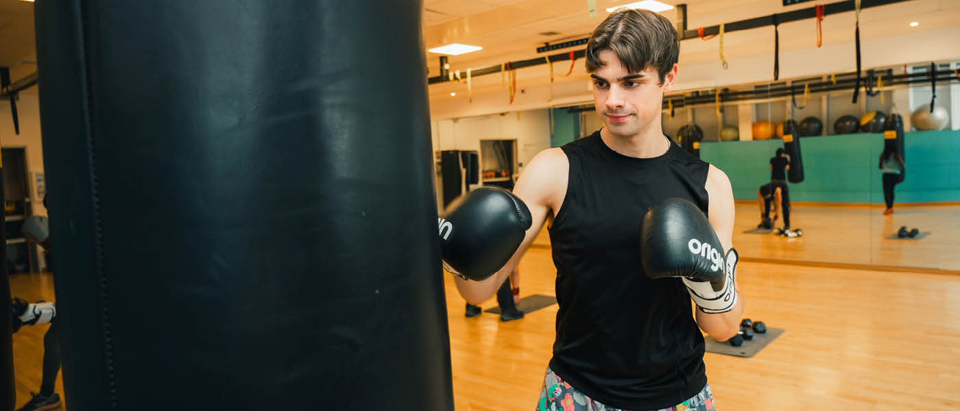 Student punching a boxing bag