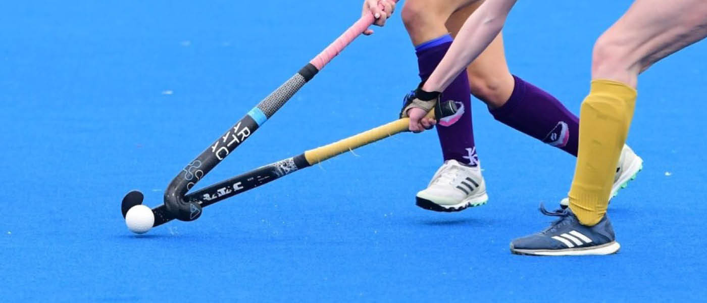 Two hockey players competing to win the ball