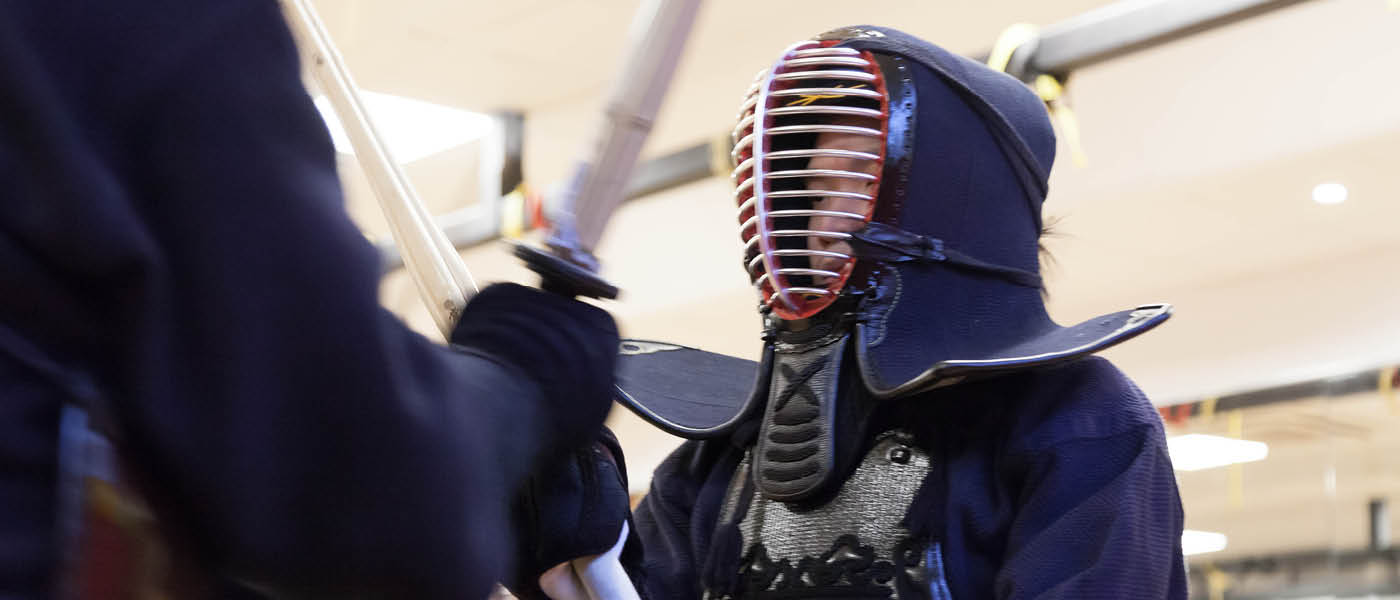 Close up of two students competing in Kendo