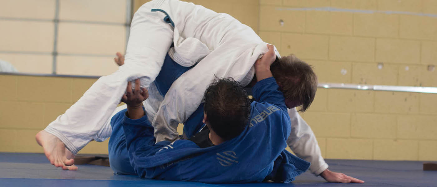Two students practicing MMA moves