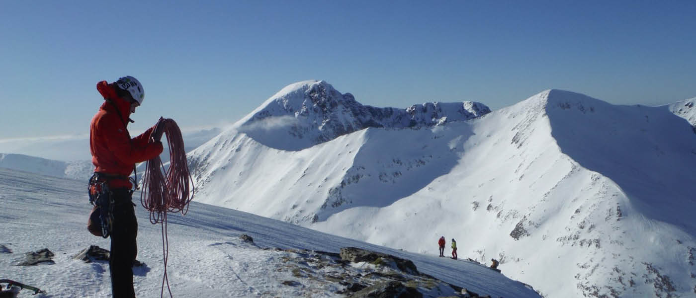 Student at the top of a snowy mountain