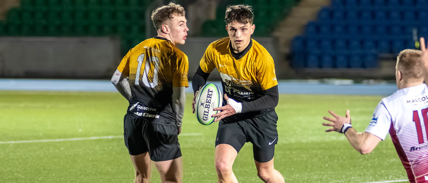 Rugby player about to pass the ball