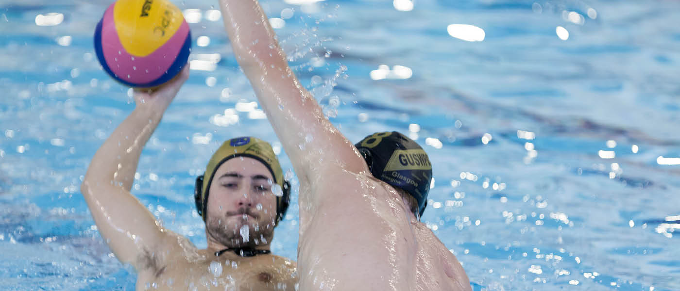 Two students competing to win the ball in a waterpolo match