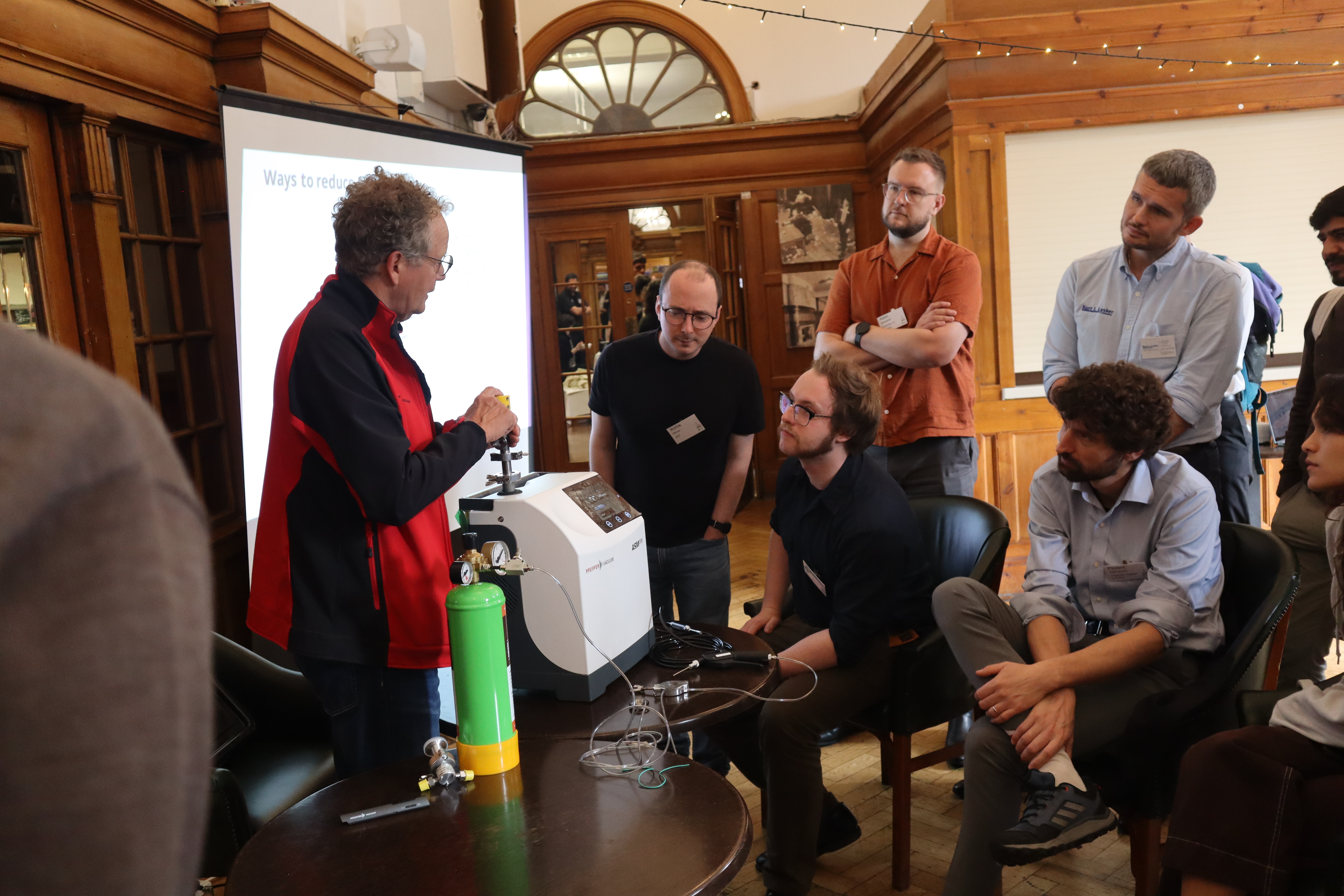 A group gathered around a workshop at nanoFabUK 2025