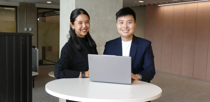 International students with laptop at the Adam Smith Business School