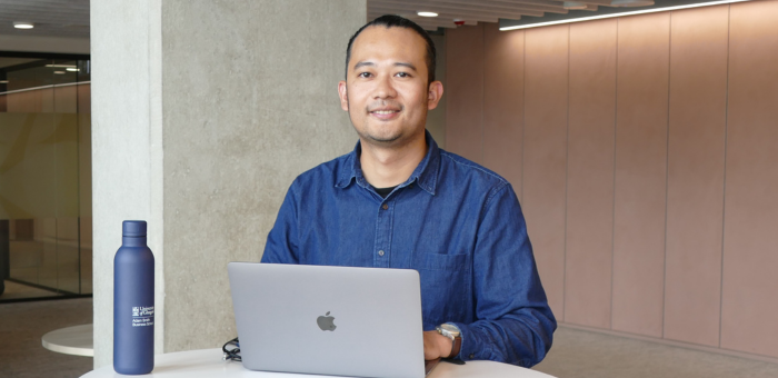 One male international student with laptop