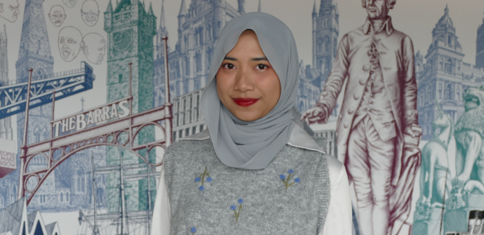 International Student in front of Adam Smith Business School Mural