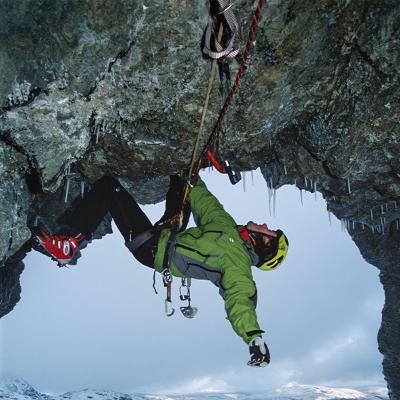 Dave Mcleod hanging from ropes on icy rock