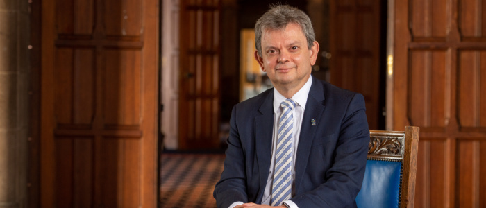 Formal head & shoulders photo of Professor Sir Anton Muscatelli wearing a suit, shirt and tie