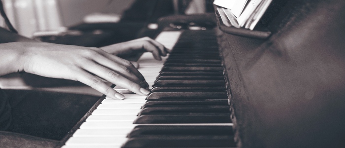 Hands playing a piano