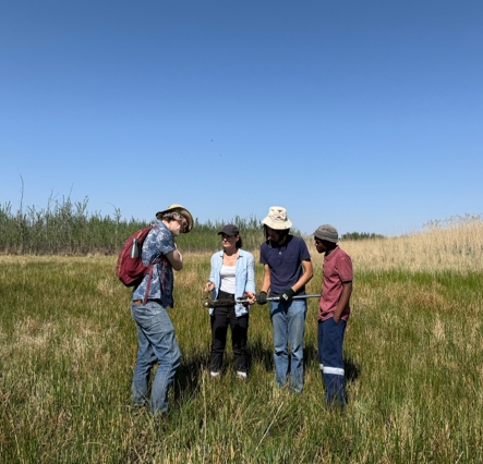 The team surveying the peatland before coring. Left to right: Prof. Frank Neumann, Dr. Bianca Cavazzin, students Tshiamo Mmatladi, and Thokozani Mahlangu. Photo credit: Alexandra Vasilyeva.