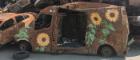 ‘car graveyard’ in Irpin, Ukraine. A stack of burned and rusted vehicles adorned with sunflower artwork. Photo by Alisa Demina (see link to JCA paper)