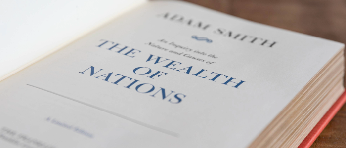 The Wealth of Nations book by Adam Smith opened to the front page