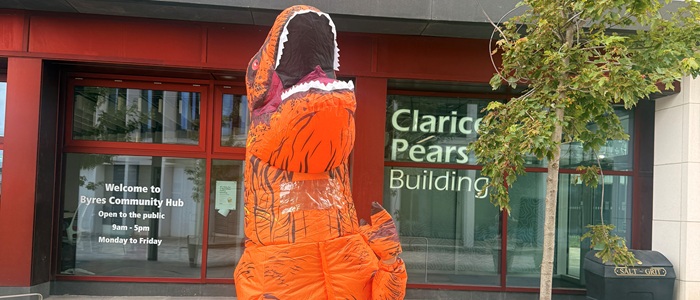 An inflatable orange dinosaur outside the Clarice Pears building