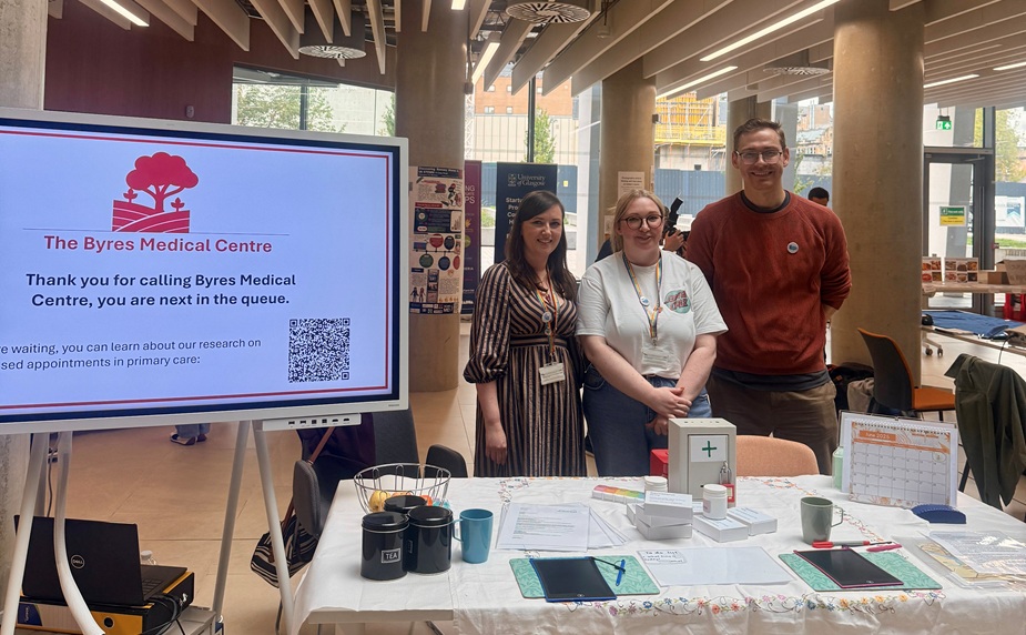 Three researchers behind a table with the activity 'Can you break into general practice?'