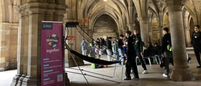 A group of students attending a team uofg together event in the cloisters