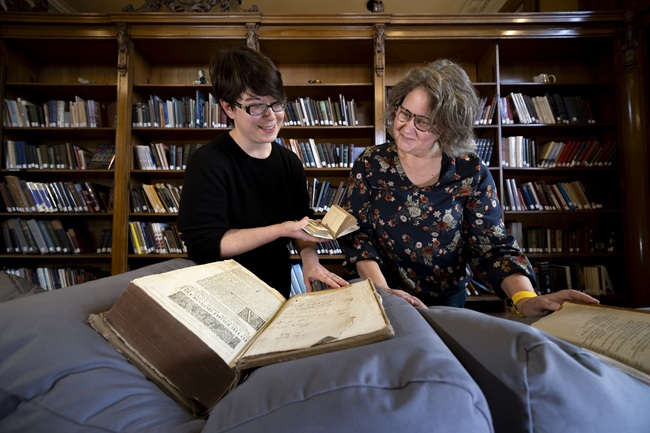 Left to Right: Dr Shanti Graheli and Susan Taylor comparing readers' marks in three of the books which will be on display at the Books ‘Antiques’ Roadshow, part of the Being Human Festival. Credit: Martin Shields