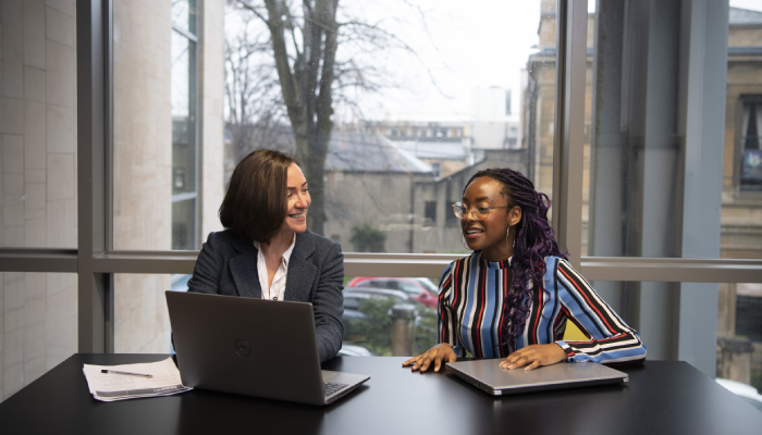 A member of staff from Student Services interviews a student.