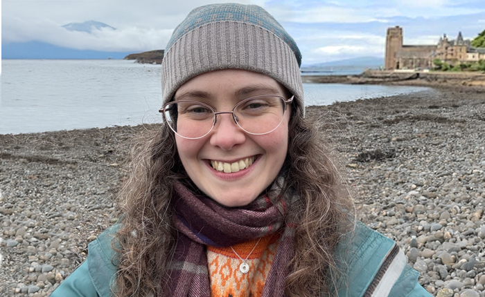 Dr Mona O'Brien, Effective Learning Adviser, standing on a sea shore for a photo